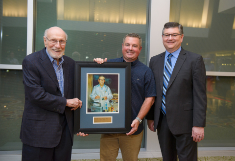 PCCA Chief Executive Officer David Sparks (left) and President Jim Smith (right) present the M. George Webber, PhD, 2019 Compounding Pharmacist of the Year Award to Jasper Lovoi III, PharmD, RPh, of The Woodlands Compounding Pharmacy in Shenandoah, Texas. (Photo: Business Wire)