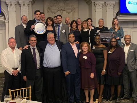 CompoSecure’s CEO Jon Wilk and team accept the 2019 Irene DeGrandpre Award from Roots & Wings (Photo: Business Wire)
