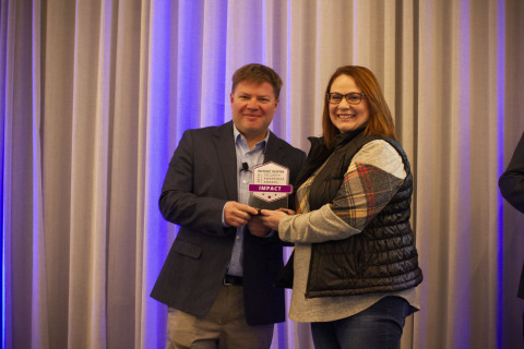 Infosec CEO Jack Koziol presents the Impact Award to Jackson County Security Risk and Compliance Analyst Donna Gomez. Photo courtesy Infosec