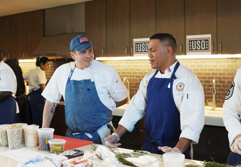 The Blue Apron Culinary team cooks alongside chefs from each branch of the military at the USO Warrior and Family Center at Bethesda on Monday, November 18. (Photo: Business Wire)