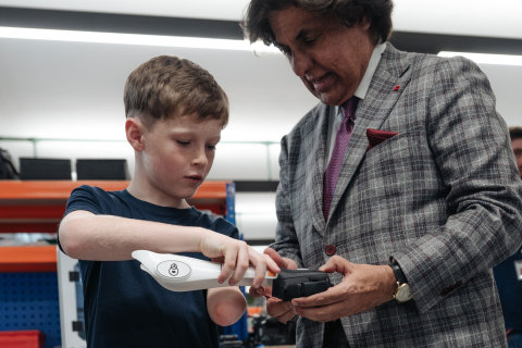 10-year-old Jacob Pickering inspects 3D printed parts of an Open Bionics hero arm with Tej Kohli Foundation co-Founder Tej Kohli (Photo: Business Wire)
