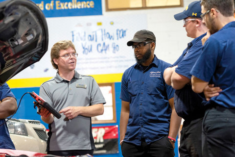 Alfred State College of Technology Instructor Jason Kellogg works with students in a recently rebranded ‘Race to 2026’ technical training facility at the school. (Photo: Business Wire)