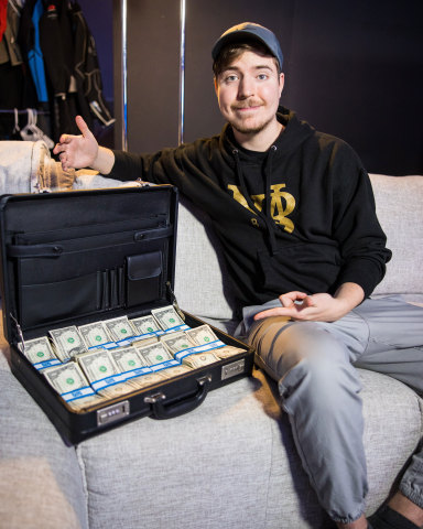 MrBeast poses with $1 million in cash (Photo: Business Wire)