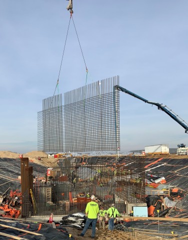 Rebar is lowered into place as construction continues on SHINE's medical isotope production facility. SHINE broke ground for the facility in Janesville, Wis., last May. Excavation began last September and the first foundational concrete was poured later in the fall. Concrete that forms the structure of the facility continues to be poured. (Photo: Business Wire)