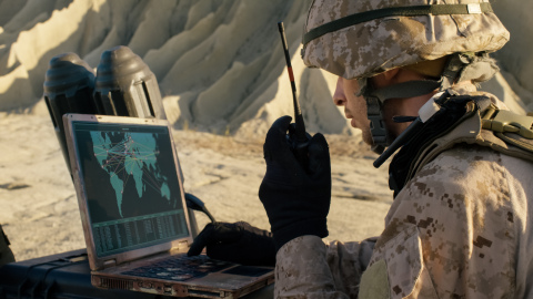 BAE Systems will provide C5ISR, technical support, and life cycle sustainment to the U.S. Navy to improve the situational awareness of military operators and decision makers. Pictured here is a soldier using a laptop and radio communications during a military peration in the desert. Credit: gorodenkoff.