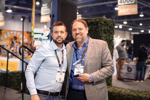 Brian Moyer, CEO of Criticality, LLC (right) accepts “Best CBD Topical” award from Ben Stimpson of The Hemp Business Magazine (Photo: Business Wire)