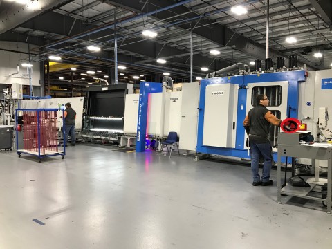 Team members operate one of PGT Innovations’ automated Thermo Plastic Spacer (TPS) lines, which spans 135-feet in length (photo year: 2020) (Photo: Business Wire)