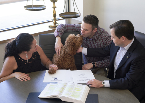 Golden doodle dubbed as @TuckerinPhilly shows his affection to parents after attorney Robin Merriman finalizes pet trust. (Photo: Business Wire)