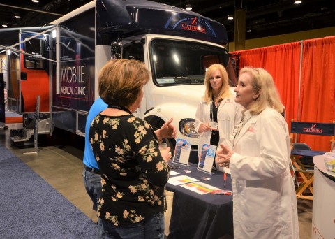 Pictured sharing information with TCA conference attendees are, (in lab coats left to right) Marybeth Morrell, MSN, RN, CCRN-K, and Karen Steffens, RN, MSN, COHN-S. (Photo: Business Wire)