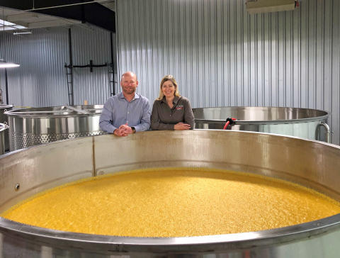 Co-owners Pete and Vienna Barger of Southern Distilling Company, pictured here by a fermentation tank containing corn mash, have shifted their craft distillery's large-scale production from whiskeys to hand sanitizer to help address the current shortage. (Photo: Southern Distilling Company)