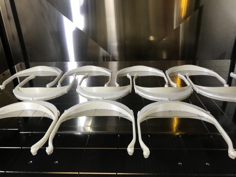A tray of face shield visors being 3D printed by Stratasys. Thousands are now being produced by Stratasys or its coalition partners. (Photo: Business Wire)