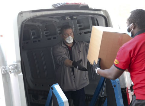 Aramark employees loading their trucks to begin the delivery of care packages for the “NYC Healthcare Heroes” program (Photo: Business Wire)