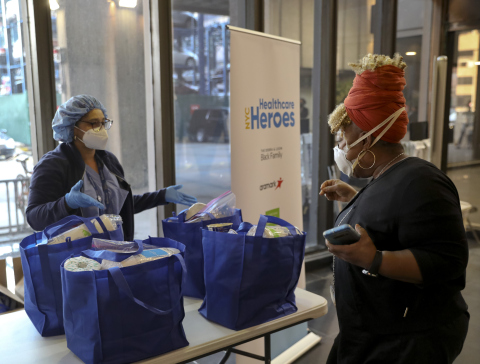 Healthcare professional accepting her first care package gifted by “NYC Healthcare Heroes” at Bellevue Hospital (Photo: Business Wire)