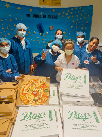 Pictured: The Emergency Room Staff at NY Presbyterian Weil Cornell Medical Center in NYC, eating Patsy’s Pizza that was donated by TSR Inc.’s “Feed The Heroes” program. (photo cred - Cora Yi)