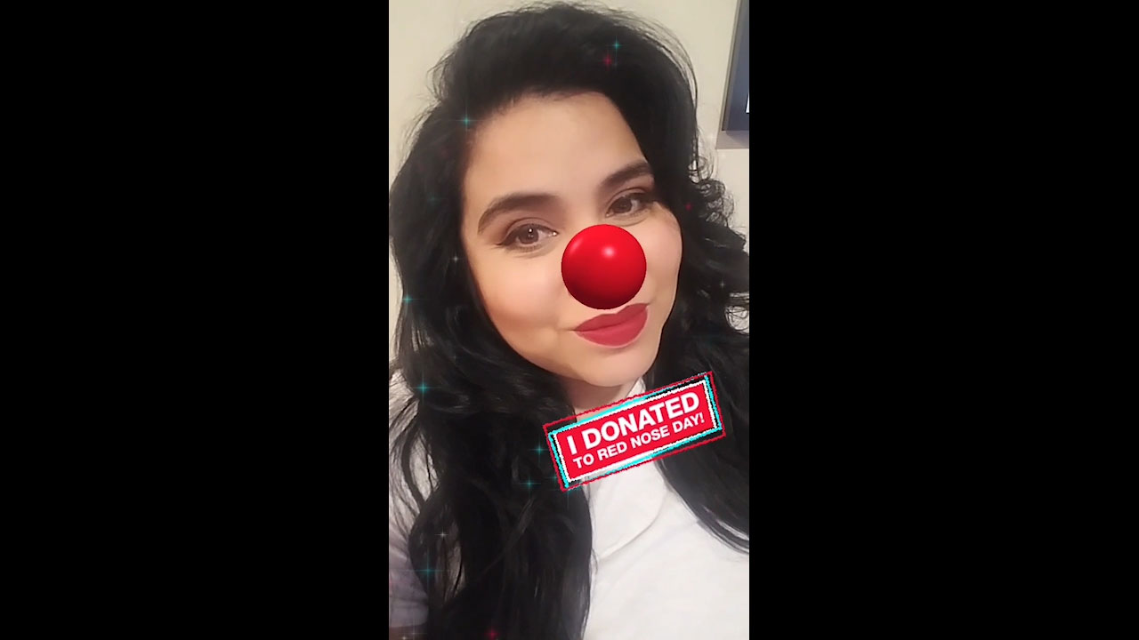 Woman shares selfie wearing digital Red Nose on social media after donating to Red Nose Day at Walgreens.com/RedNoseDay