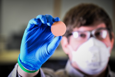 ExOne R&D Manager Kyle Myers, PhD, with a 3D printed porous copper filter, now in testing, that is reusable, sterilizable and sustainable, eliminating waste. The filter fits into a cartridge designed by Pitt, and it can be printed to fit a variety of medical needs. (Photo: Business Wire)