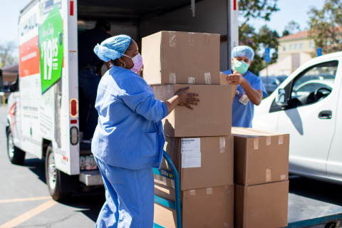 Hospital workers at Dignity Health in Santa Maria, California unload thousands of protective gowns donated by CenCal Health. (Photo: Business Wire)