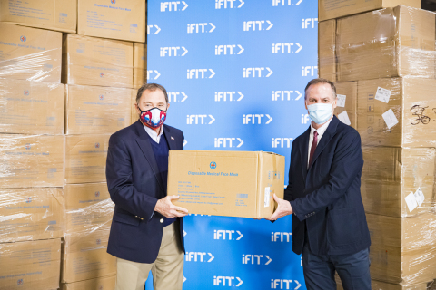 iFit CEO Scott Watterson (right) presents Utah Governor Gary Herbert with a donation of one million medical-grade surgical masks. (Photo: Business Wire)