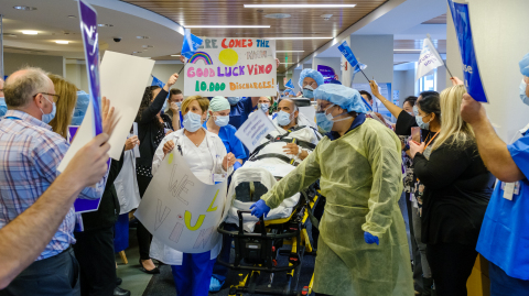 Staff at Northern Westchester Hospital in Mount Kisco, NY, cheer on Friday’s release of a patient who recovered from COVID-19, symbolically marking the 10,000th discharge of a patient treated for the Coronavirus at a Northwell hospital since the pandemic struck New York in March. (Credit: Northwell Health)