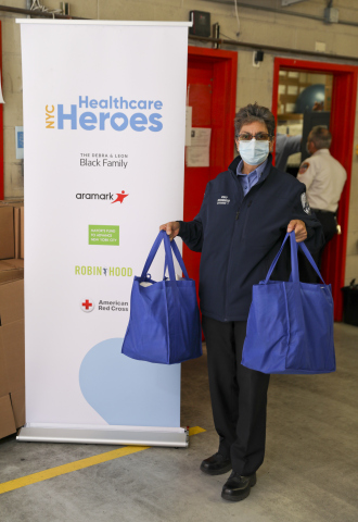 FDNY EMS member holding her first care package of shelf-stable food, household cleaning and personal care products, as well as over-the-counter medicine provided by NYC Healthcare Heroes (Photo: Business Wire)