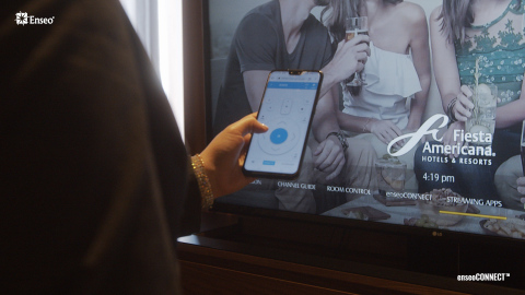 A guest navigates the TV options using the enseoCONNECT™ mobile remote on their own smartphone. (Photo: Business Wire)