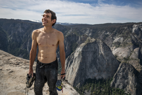 Alex Honnold holds all of his climbing gear atop the summit of El Capitan. He just became the first person to climb El Capitan without a rope. (Credit: National Geographic/Jimmy Chin)