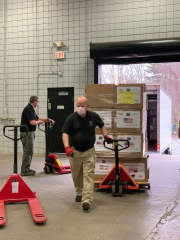 The Massachusetts Emergency Management Agency unloading and preparing to distribute PPE provided by Home Credit. (Photo: Business Wire)