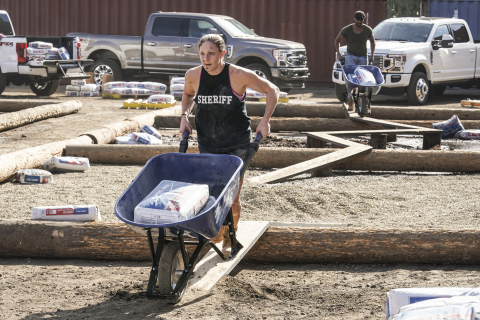Competitors race wheel barrows of SPEC MIX mortar in a job-site challenge on the new CBS show, TOUGH AS NAILS. (Photo: Business Wire)