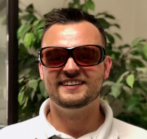 UC Davis Eye Center color blind study participant Alex Zbylut wearing EnChroma glasses for color blindness (Photo: Business Wire)