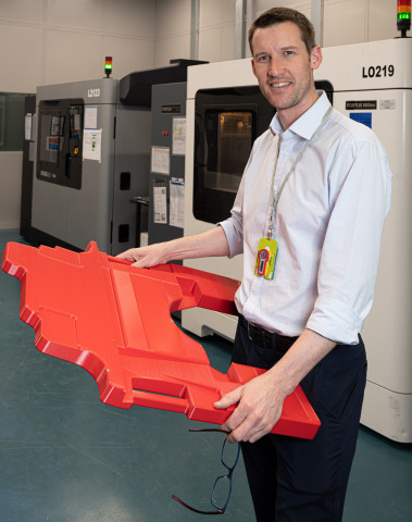 Greg Flanagan, additive manufacturing operations lead, BAE Systems Air, with a 3D-printed Typhoon cockpit floor cover (Photo: Business Wire).