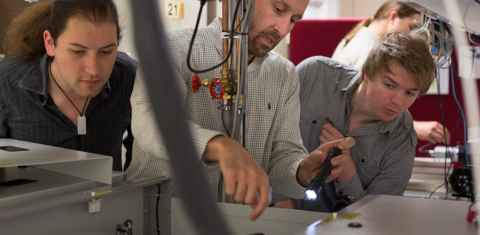 Faccio, center, working on laser system alignment and optimization with student Mihail Petev, left, and Niclas Westerberg, a Leverhulme fellow in the School of Physics and Astronomy. (Photo: Business Wire)