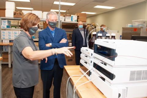 Leitha Boutwell, COO of Coast Diagnostics in Mobile, AL, reviews COVID-19 testing equipment with US Senate Candidate Tommy Tuberville while Coast CEO Brian Ward looks on. (Photo: Business Wire)