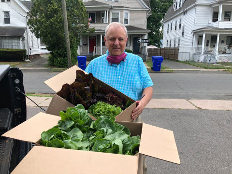original Bakery On Main's President and Founder, Michael Smulders delivers fresh organic produce grown in the Growing Roots Community Garden to East Hartford's Senior Center. (Photo: Business Wire)