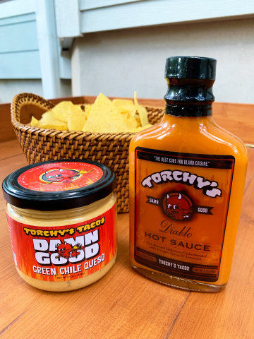 For the first time ever, fans of Torchy’s Tacos, the Austin-based craft casual taco brand, will be able to purchase its signature Green Chile Queso and Diablo Sauce at participating Whole Foods locations in Texas, Arkansas, Oklahoma and Louisiana. (Photo: Business Wire)