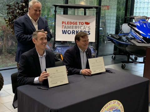 During a visit with U.S. Secretary of the Interior David Bernhardt (standing) at Yamaha's facility in Newnan, Ga., Mike Chrzanowski, President of Yamaha Motor Manufacturing Corporation (seated left) and Ben Speciale, President of Yamaha U.S. Marine Business Unit (seated right) signed the Pledge to America's Workers, reinforcing Yamaha's commitment to workforce development. (Photo: Business Wire)