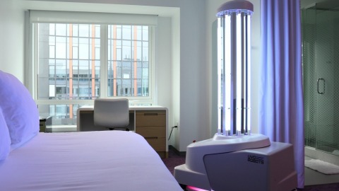 original “Right now it’s critical for the hospitality industry to not only enhance how we protect travelers but also provide them with reassurance that we’re taking every possible step from check-in to check-out,” said Trish Berry, General Manager, YOTEL Boston. An extension of YOTEL’s operation #SmartStay safety measures, the UVD Robot, named ‘Vi-YO-Let’, will offer an even deeper level of disinfection throughout high-touch public spaces and select cabins at YOTEL Boston. Photo credit: YOTEL Boston.