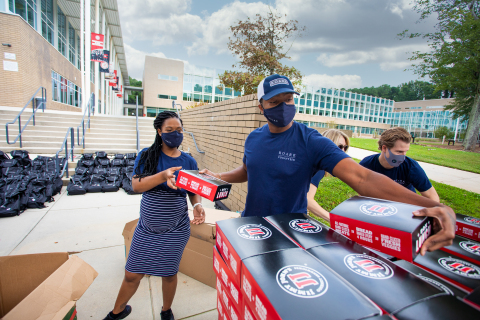 Roark team members prepare lunch boxes from Jimmy John’s for event attendees. (Photo: Business Wire)