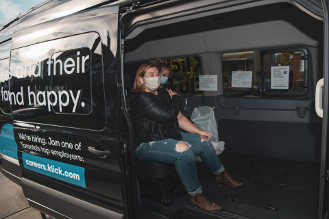 A registered nurse gives copywriter Ammie Matte the flu shot in Klick Health's Mobile Flu Shot Clinic outside her Toronto home on October 28, 2020. Matte is one of hundreds of Klick employees who signed up for the unique program as the company continues to adapt its people-first programs during the pandemic. (Photo: Business Wire)