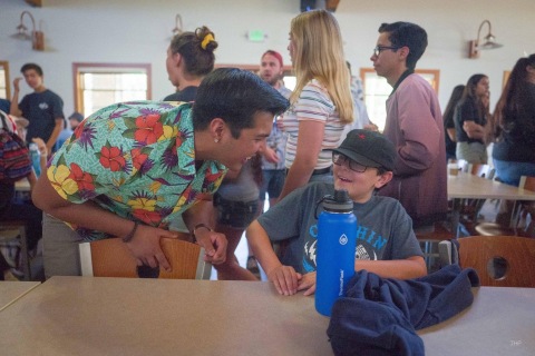 CEO of OURA and camp graduate, Keane Veran, sharing some laughs with Carson, a current camper, during his time volunteering as a counselor at Camp Ronald McDonald for Good Times. (Photo: Business Wire)