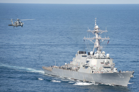 A U.S. Navy Seahawk helicopters flies nearby USS Stout (DDG 55) at sea. BAE Systems’ Norfolk shipyard will begin working aboard the 510-foot-long U.S. Navy destroyer in January 2021. (Photo: U.S. Navy)