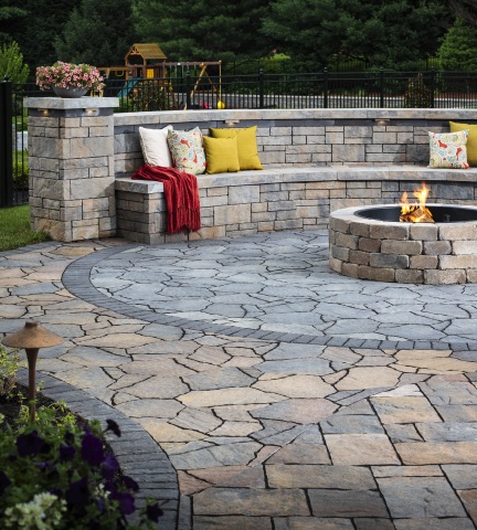 Belgard outdoor living featuring Mega-Lafitt® Paver, Tandem™ Wall and Weston Stone™ Fire Pit with Color of the Year, Marigold, as an accent color. (Photo: Business Wire)