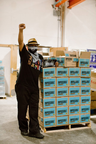 Roberto Hernandez of Mission Food Hub prepares for a distribution event in San Francisco after receiving a donation from Impossible Foods and Know Your Rights Camp. (Photo: Business Wire)