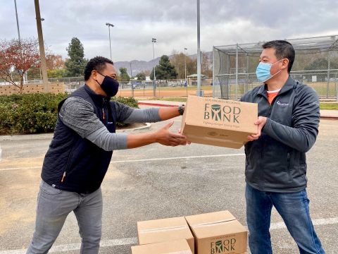 (L to R) Antoinne Harris, VP Operations, San Fernando Valley Region Optum California and Derek Caho, M.D., Chief Medical Officer, Optum California, sort food kits during a food donation event where Optum announced a partnership with Wider Circle to donate 25,000 healthy meals to families in need during the holiday season. (Photo: Business Wire)