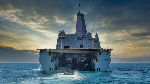 An Amphibious Combat Vehicle embarks a large naval ship during swim testing in the Pacific Ocean. (Photo: BAE Systems)
