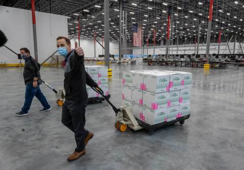At McKesson’s Olive Branch, Miss. distribution center, a McKesson operations supervisor celebrates as the Moderna COVID-19 vaccine doses are moved to the shipping area. (Photo: Business Wire)