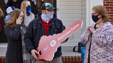 Wells Fargo's Lynne Walters presented retired U.S. Marine Corps Staff Sergeant Clint Myatt, his wife Jacki, and their six children with keys to their Tarboro, N.C. mortgage-free home just in time for the holidays. (Photo: Wells Fargo)