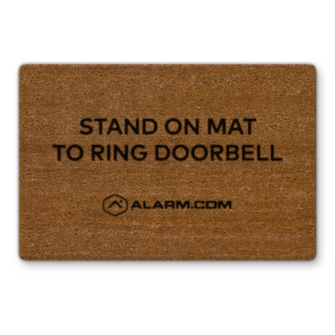 An accessory mat lets visitors know where to stand to automatically ring the Alarm.com Touchless Video Doorbell. (Photo: Business Wire)
