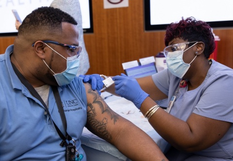 UNC Health administered its 100,000th COVID-19 vaccination today (February 2, 2021) since it began on December 15, 2020. In this photo, a UNC Medical Center employee receives his vaccination at the co-worker clinic in Chapel Hill. (Photo: Business Wire)