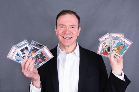 Ken Goldin poses with $8 million worth of rare trading cards all currently up for bids (Photo: Business Wire)