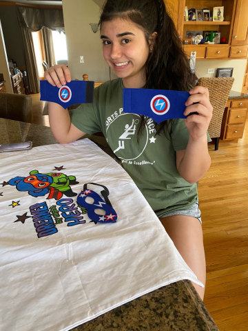 thumbnail Gianna, daughter of Michele Ptaszek, ComEd’s manager of customer education and marketing from Naperville, IL, displays superhero armbands and one of the pillowcases she created for foster children as part of The Safer at Home Superhero Project for National Volunteer Month. (Photo: Business Wire)
